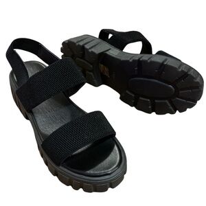 Chunky black platform sandals with stretchy strap